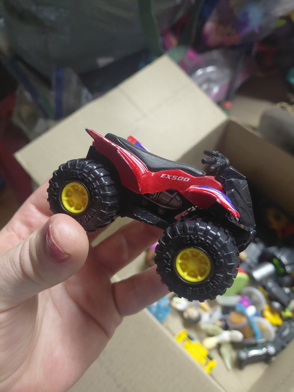 a Greenbrier International EX500 3-inch die-cast red quad ATV toy,